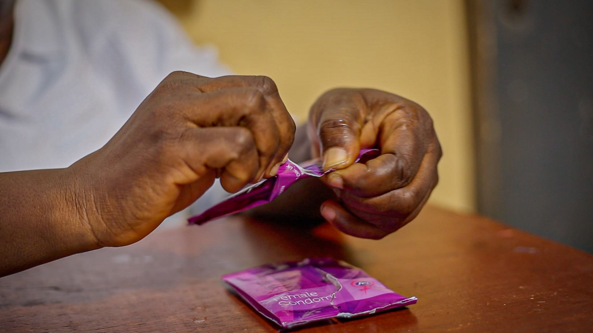 Woman opening condom package