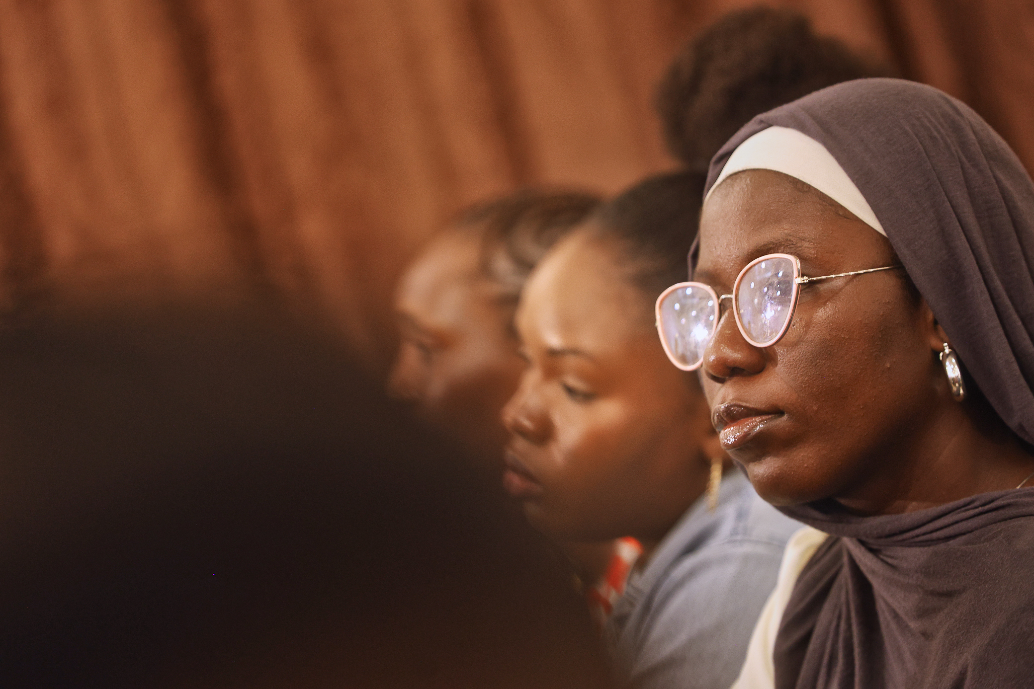 A female participant at the event, she is wearing glasses with a hijab.